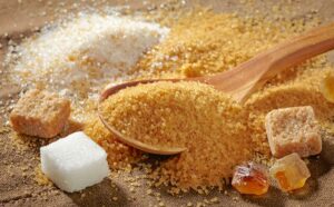 A plenty of various sugar types over a wooden table