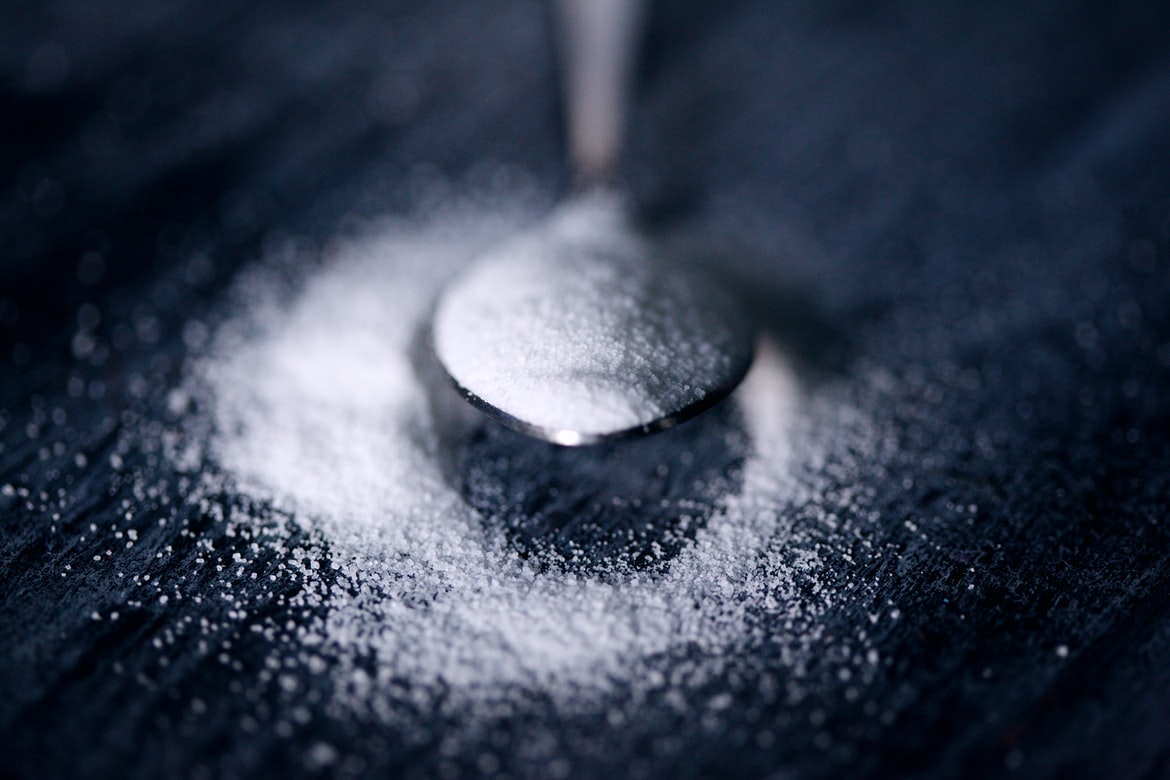 White Refined Sugar dropped on a Spoon