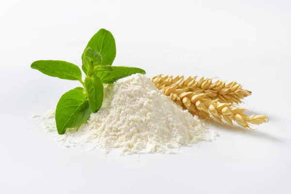 soft-wheat-pile-milled-flour-and-leaves Milled Soft Wheat on flour pile with some wheat branches and its leaves