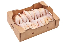 raw peel chicken breasts pieces arranged inside brown carton box ready to freeze to export