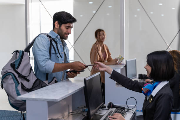 Group of airline tourist traveler waiting for luggage loading and boarding pass at airport check-in counter. Oversea holiday travel transportation aviation passenger concept.