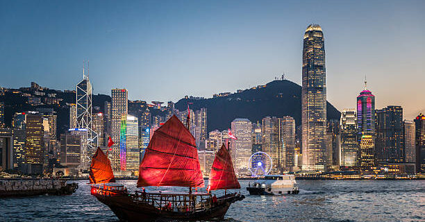 Traditional junk boat sailing across Victoria Harbour, Hong Kong.