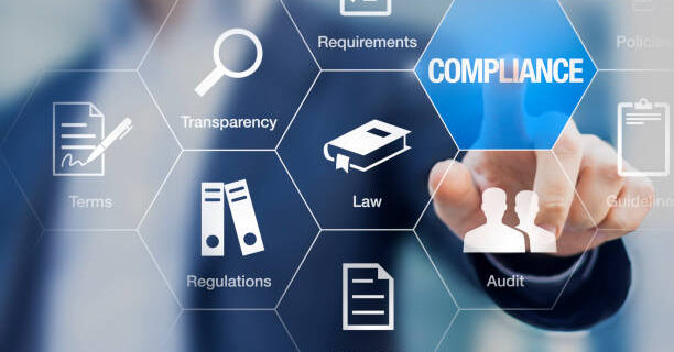 Compliance concept with icons for regulations, law, standards, requirements and audit on a virtual screen with a business person touching a button