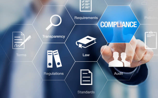 Compliance concept with icons for regulations, law, standards, requirements and audit on a virtual screen with a business person touching a button