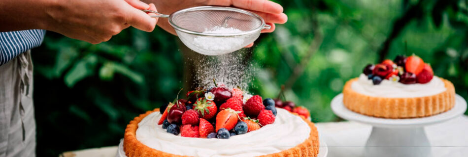 Woman preparing fresh fruits and berries cake