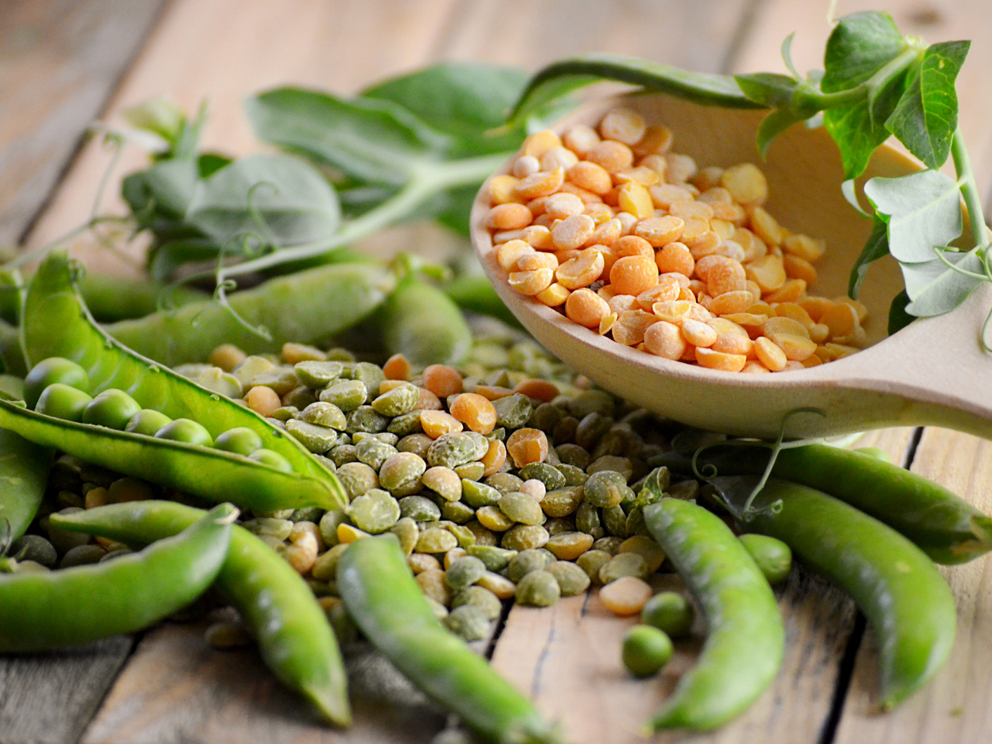 young green peas in pods and dry grains